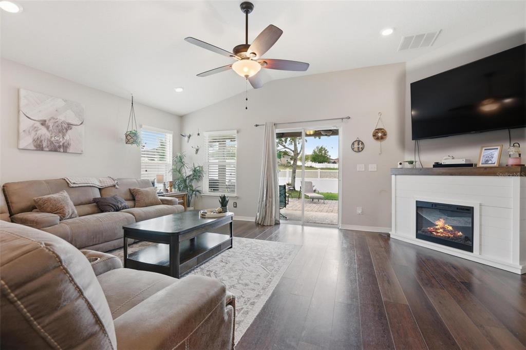 656 Carya Court DeLand, FL 32724 - Photo 7 of 28 a living room with furniture fireplace and flat screen tv