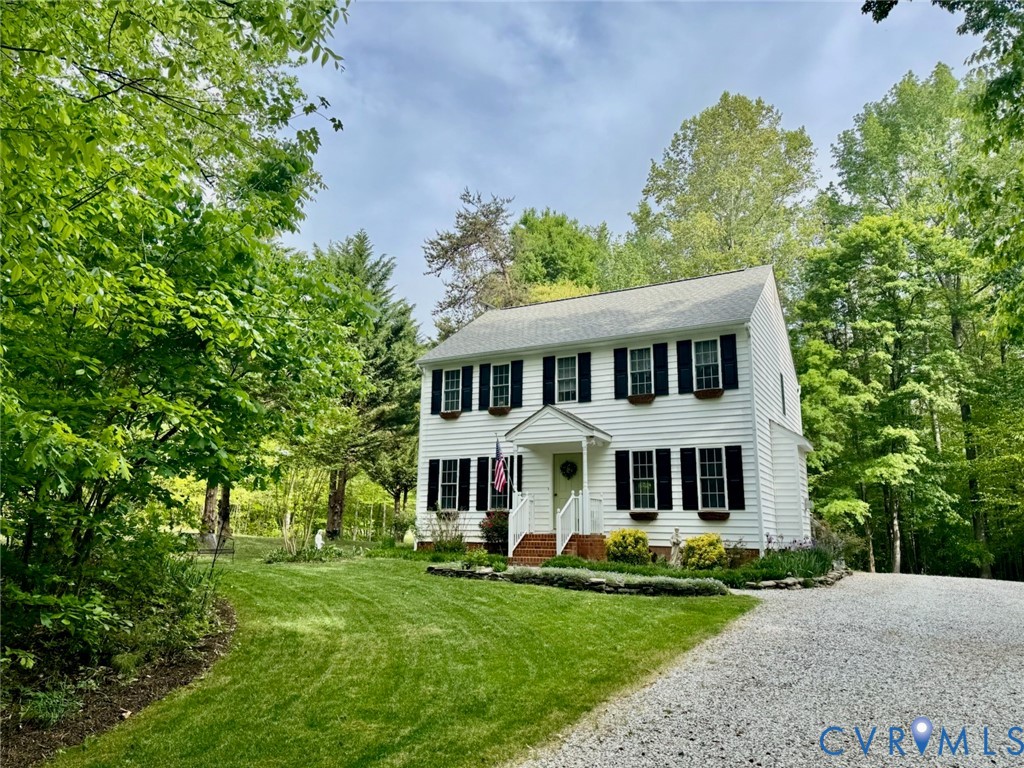 1570 Rock Castle Road Goochland, VA 23063 - Photo 3 of 3 a view of a white house with a yard and plants