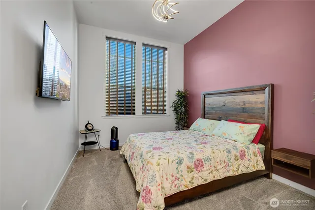 a bedroom with a bed and a flat screen tv