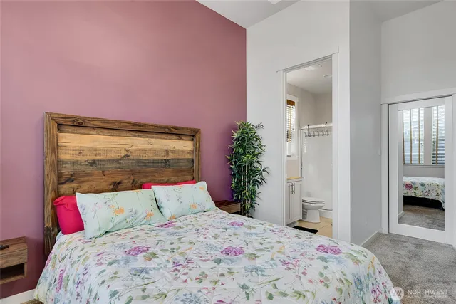 a bedroom with a bed and a potted plant