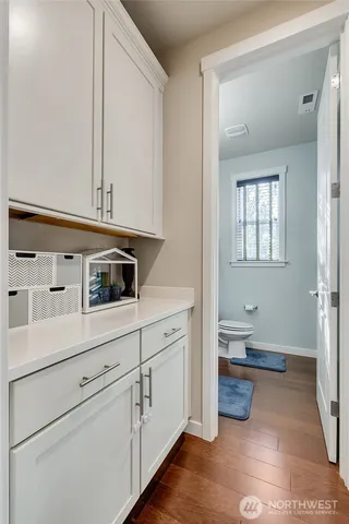 a kitchen with a sink and wooden floor