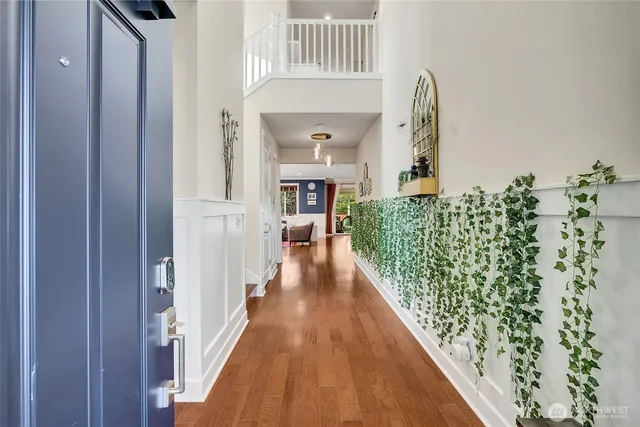 a view of a hallway with wooden floor and staircase