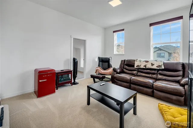 a view of a workspace with furniture and a window