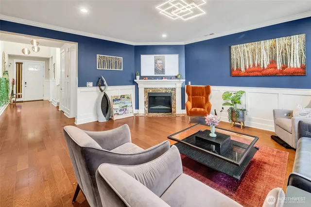 a living room with furniture pool table and a fireplace