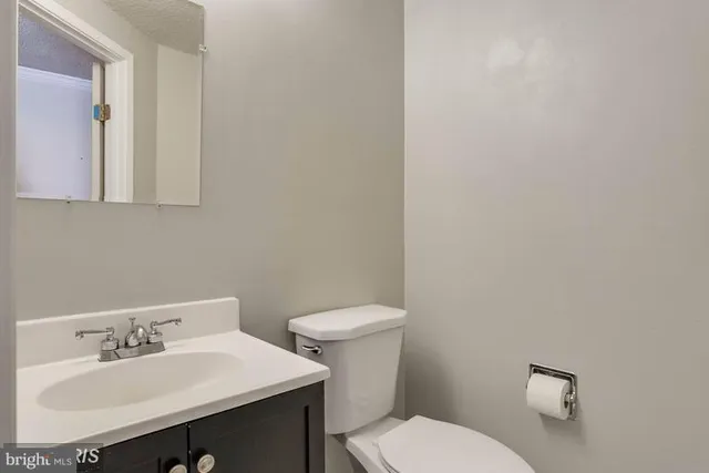 a bathroom with a sink a toilet and mirror