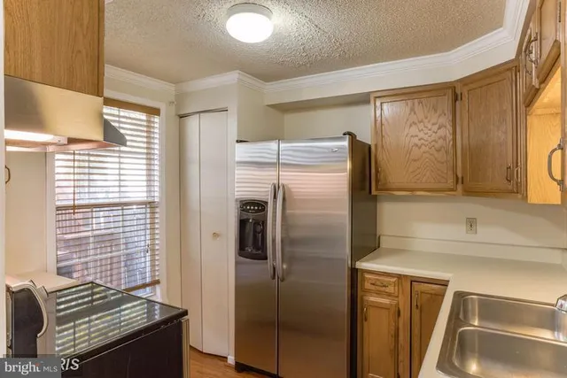 a kitchen with a refrigerator and a sink