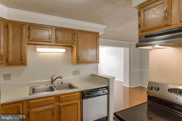 a kitchen with a sink cabinets and appliances