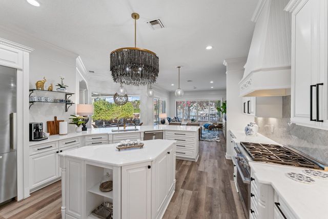 a living room with furniture potted plant and a wooden floor