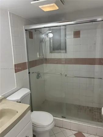 a bathroom with a shower a toilet and sink