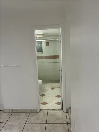 a bathroom with a granite countertop window and a shower