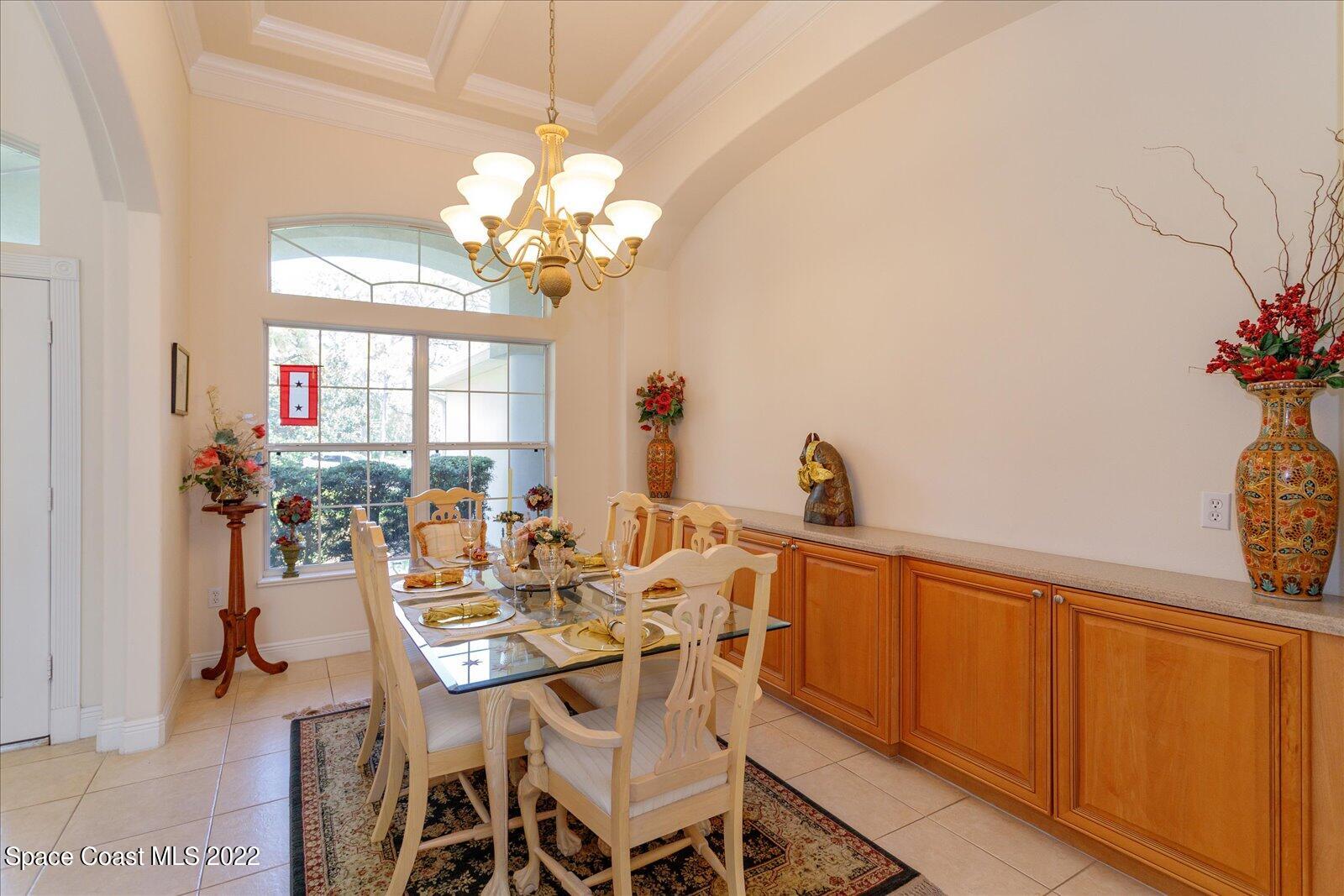 3720 Pine Cone Road Melbourne, FL 32934 - Photo 11 of 34 a view of a dining room with furniture and a chandelier