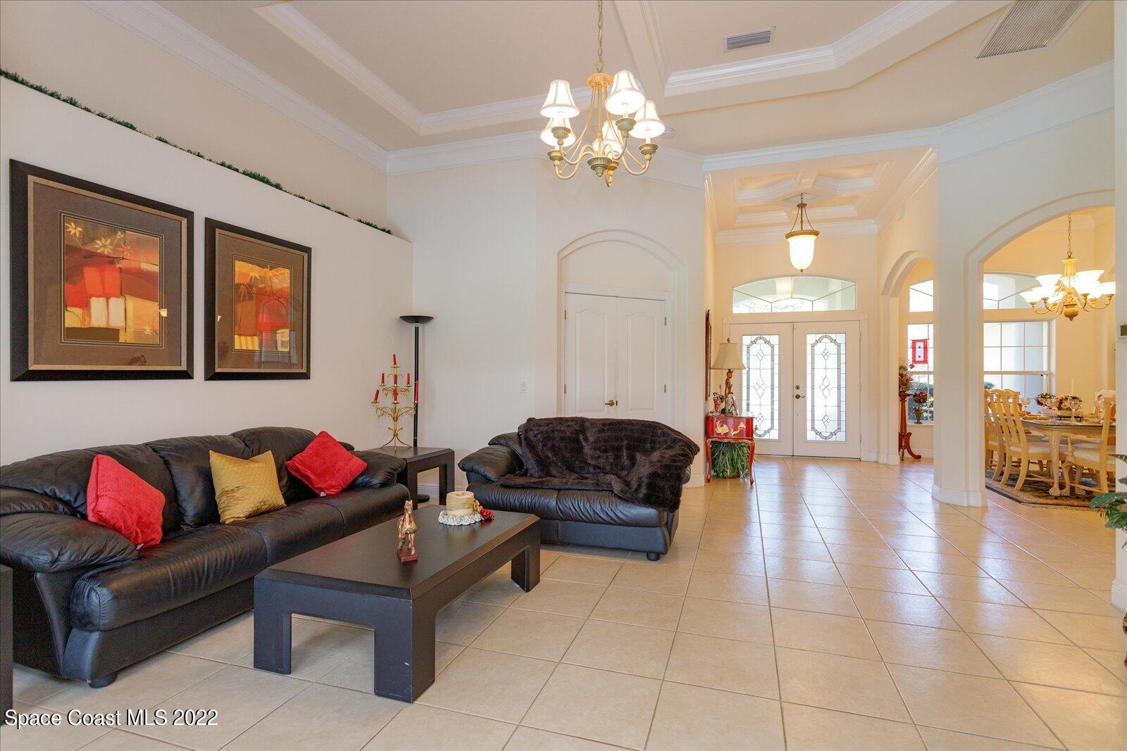 3720 Pine Cone Road Melbourne, FL 32934 - Photo 14 of 34 a living room with furniture and a chandelier