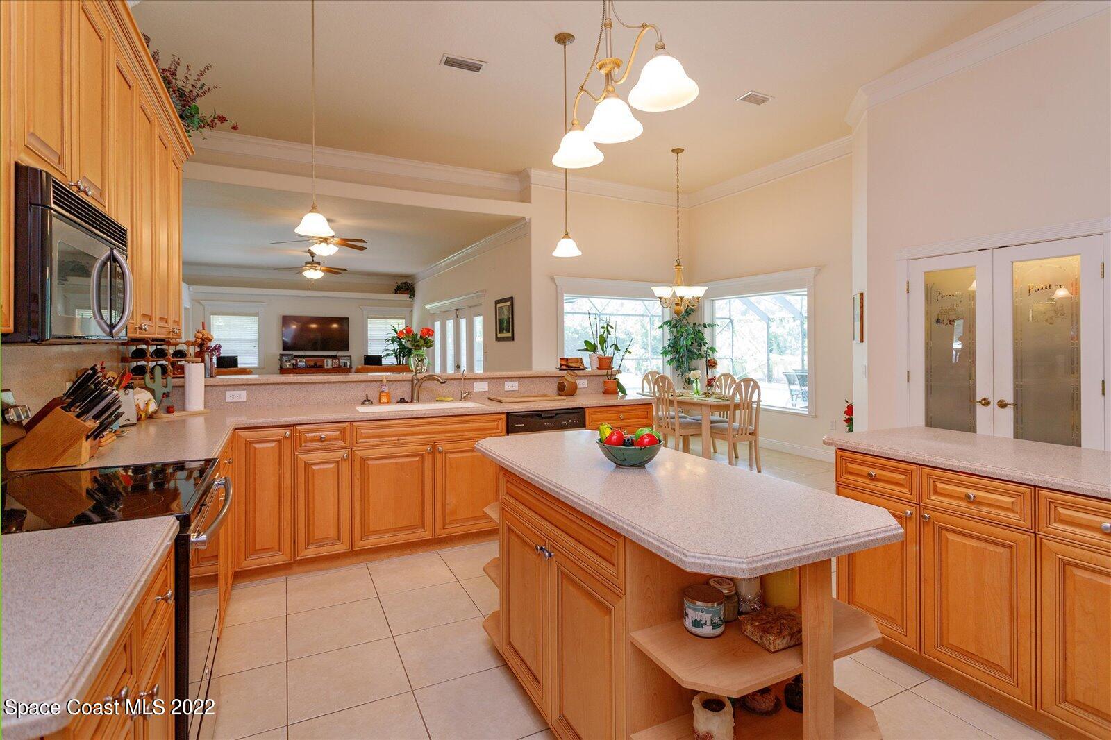 3720 Pine Cone Road Melbourne, FL 32934 - Photo 18 of 34 a kitchen with stainless steel appliances granite countertop a sink a stove and a refrigerator