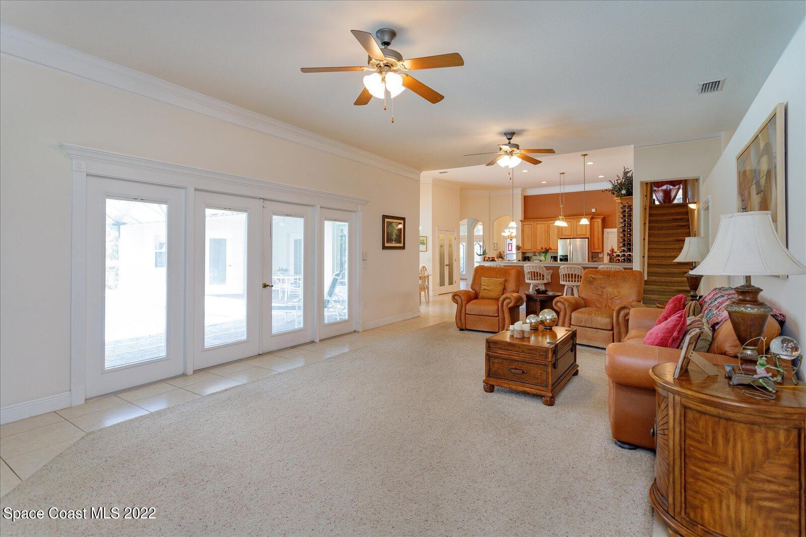 3720 Pine Cone Road Melbourne, FL 32934 - Photo 20 of 34 a living room with furniture and a chandelier