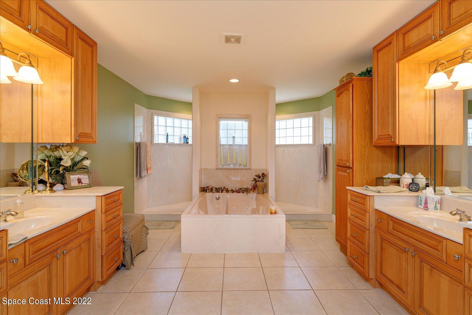 3720 Pine Cone Road Melbourne, FL 32934 - Photo 23 of 34 a large white kitchen with a large window and stainless steel appliances