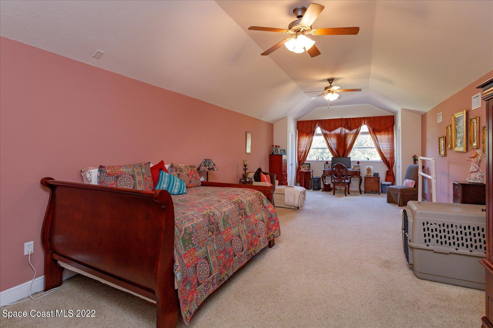 3720 Pine Cone Road Melbourne, FL 32934 - Photo 24 of 34 a bed room with a bed and a chandelier