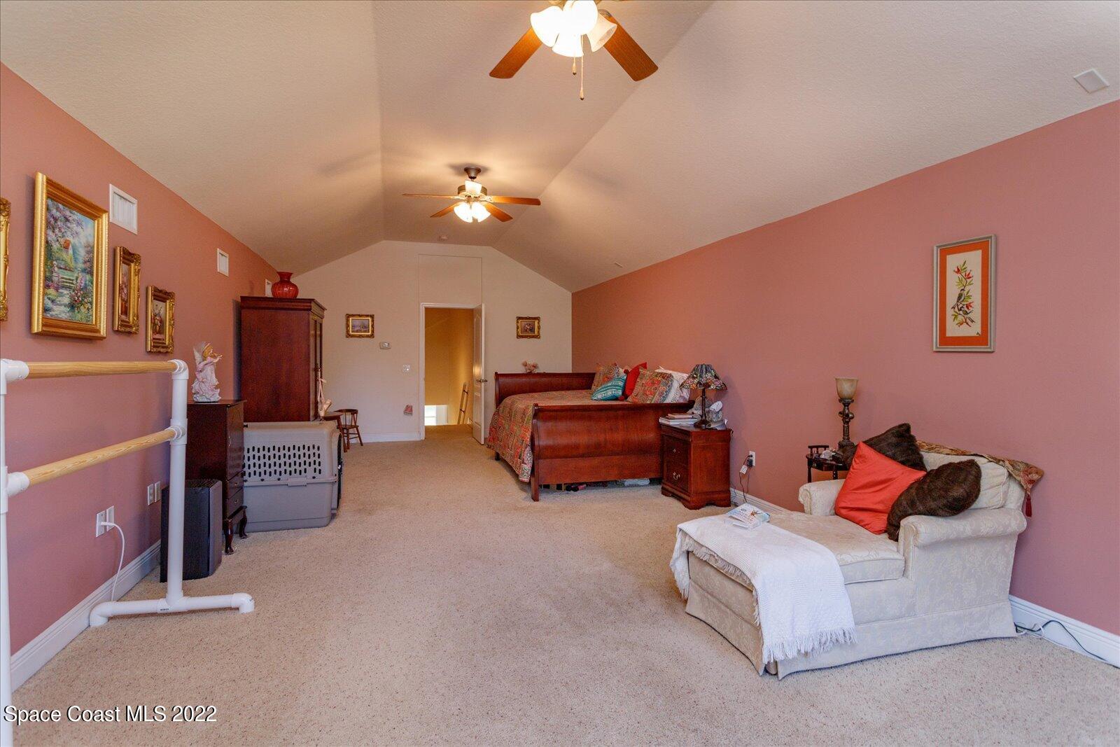 3720 Pine Cone Road Melbourne, FL 32934 - Photo 25 of 34 a living room with furniture and a chandelier