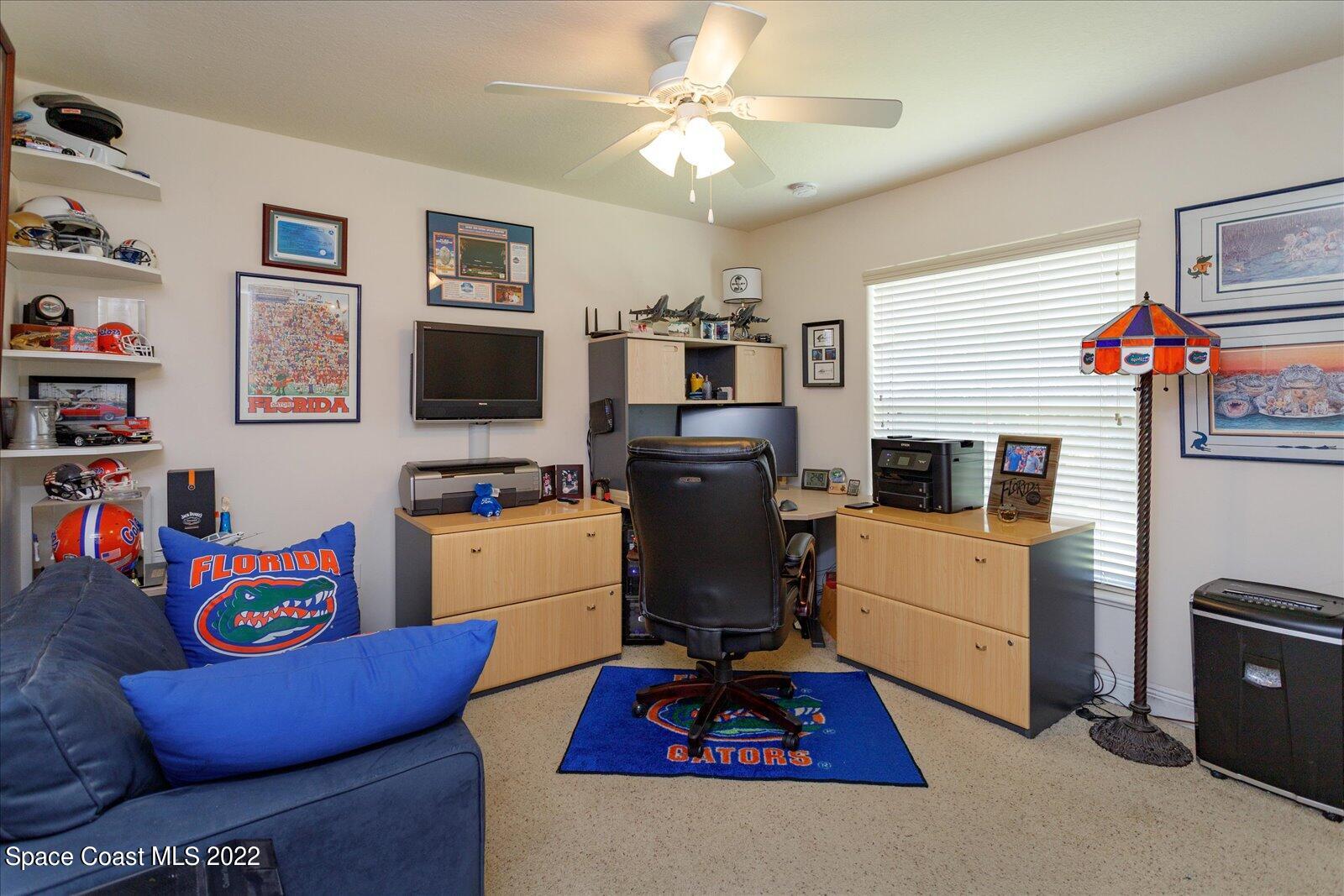 3720 Pine Cone Road Melbourne, FL 32934 - Photo 26 of 34 a living room with furniture and a flat screen tv