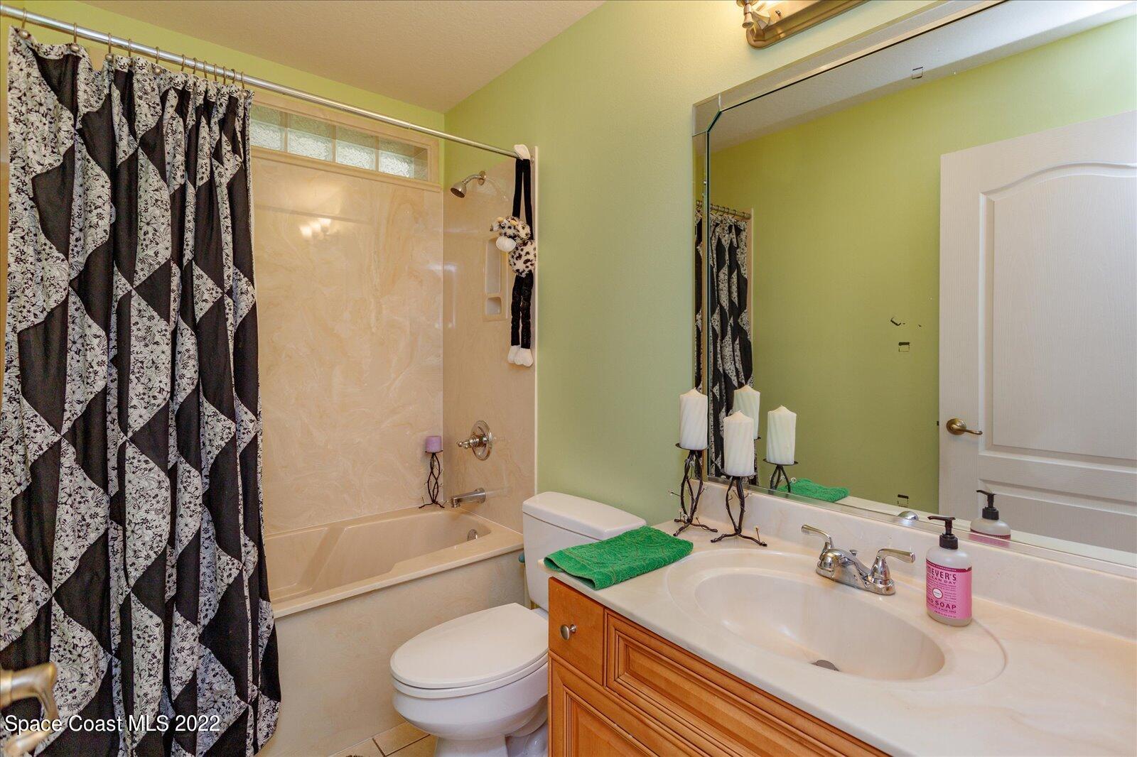 3720 Pine Cone Road Melbourne, FL 32934 - Photo 29 of 34 a bathroom with a sink toilet and shower
