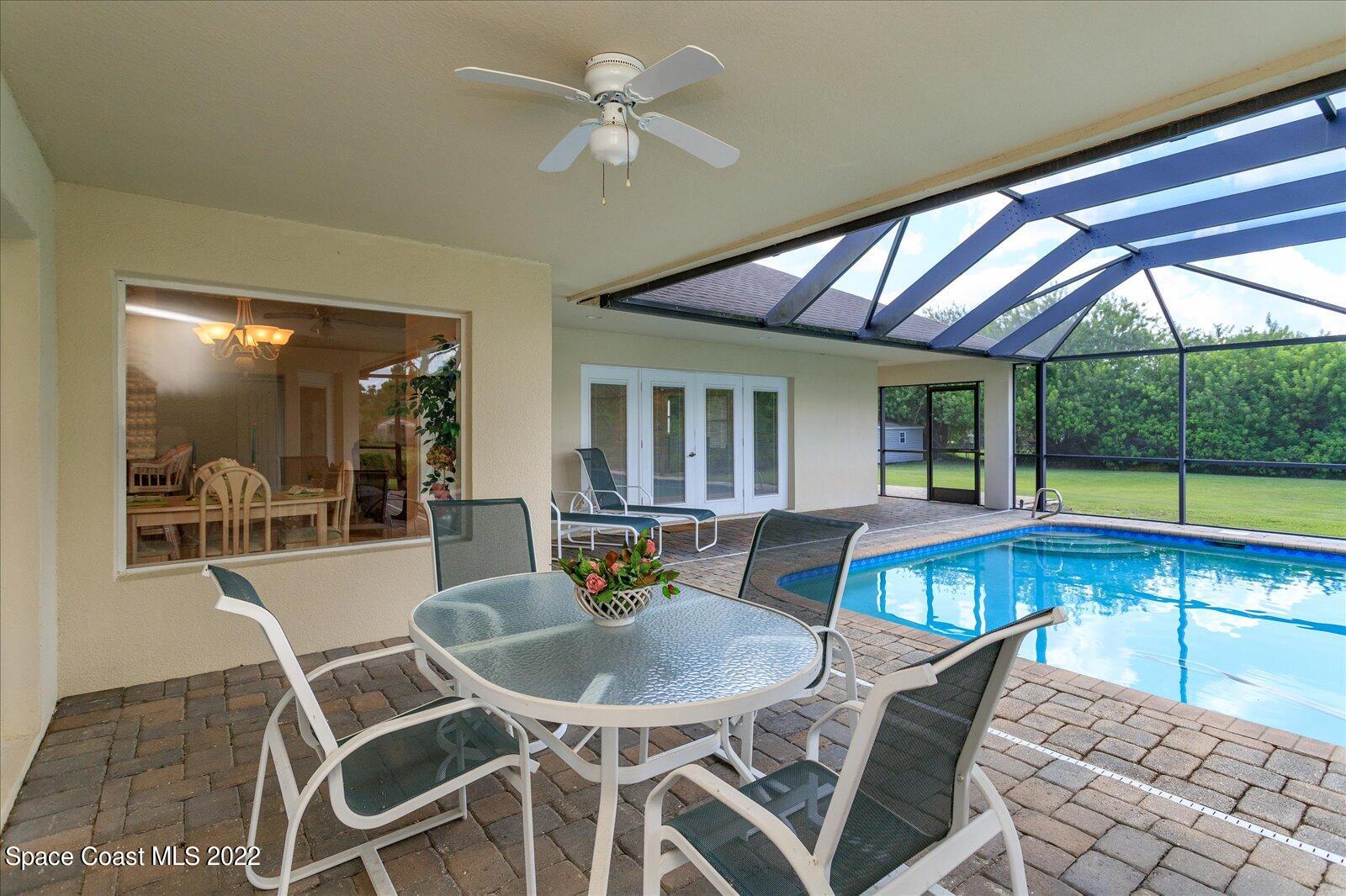 3720 Pine Cone Road Melbourne, FL 32934 - Photo 33 of 34 a dining room with furniture a rug and a large window