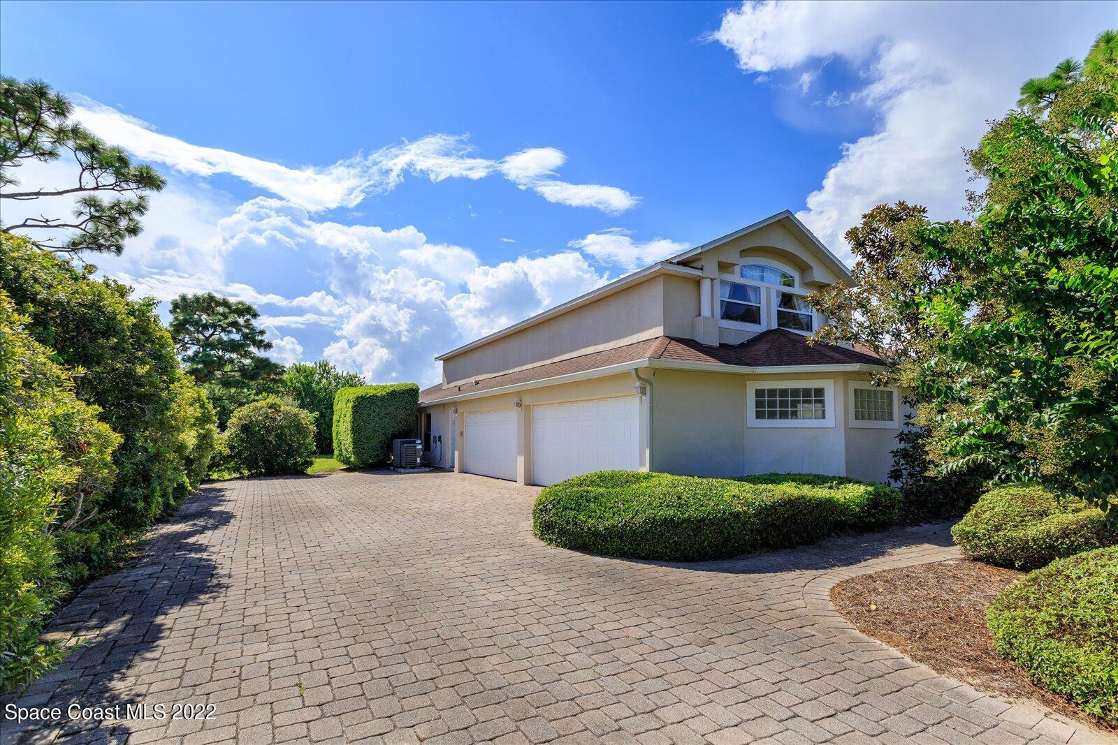 3720 Pine Cone Road Melbourne, FL 32934 - Photo 5 of 34 a front view of a house with a yard