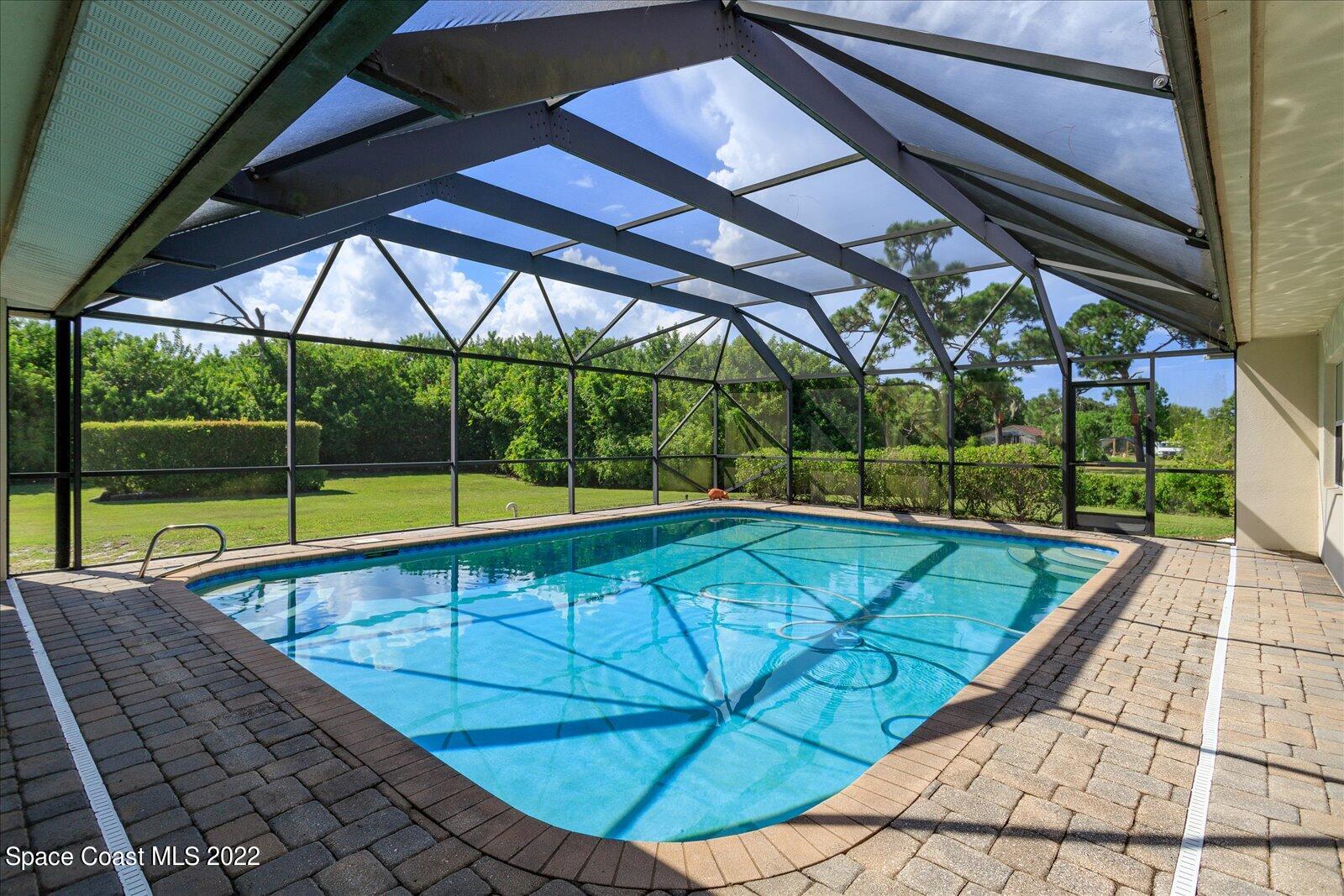 3720 Pine Cone Road Melbourne, FL 32934 - Photo 9 of 34 a view of a swimming pool with a porch