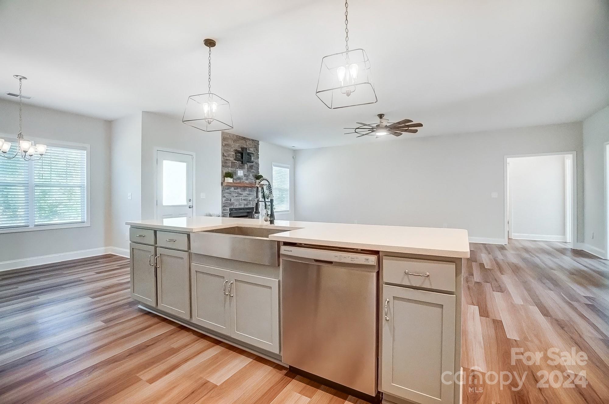 1413 Hamilton Crossroads Road Marshville, NC 28103 - Photo 15 of 42 a open kitchen with white cabinets and wooden floor