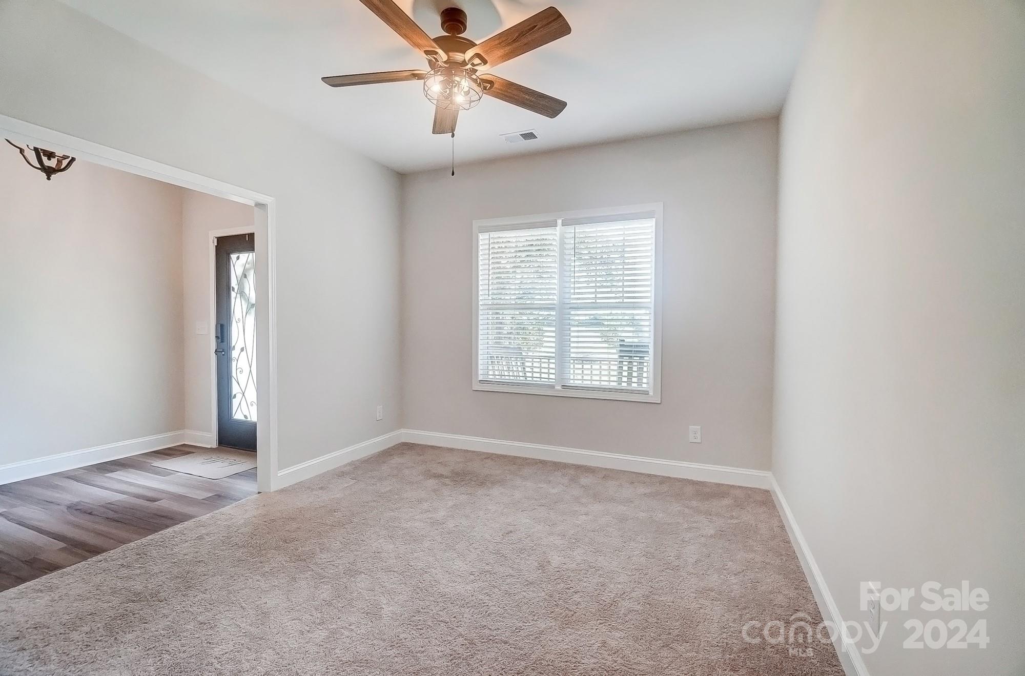 1413 Hamilton Crossroads Road Marshville, NC 28103 - Photo 19 of 42 an empty room with windows and fan