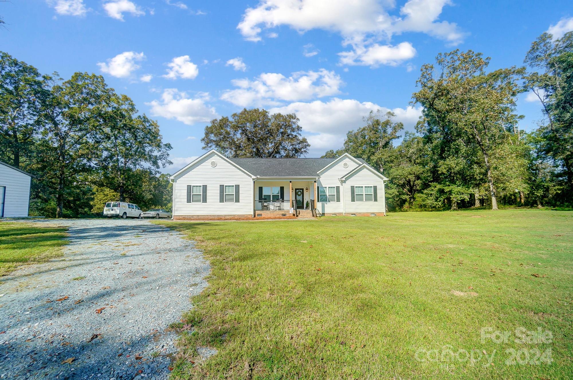 1413 Hamilton Crossroads Road Marshville, NC 28103 - Photo 2 of 42 a white house with a big yard and large trees with wooden fence