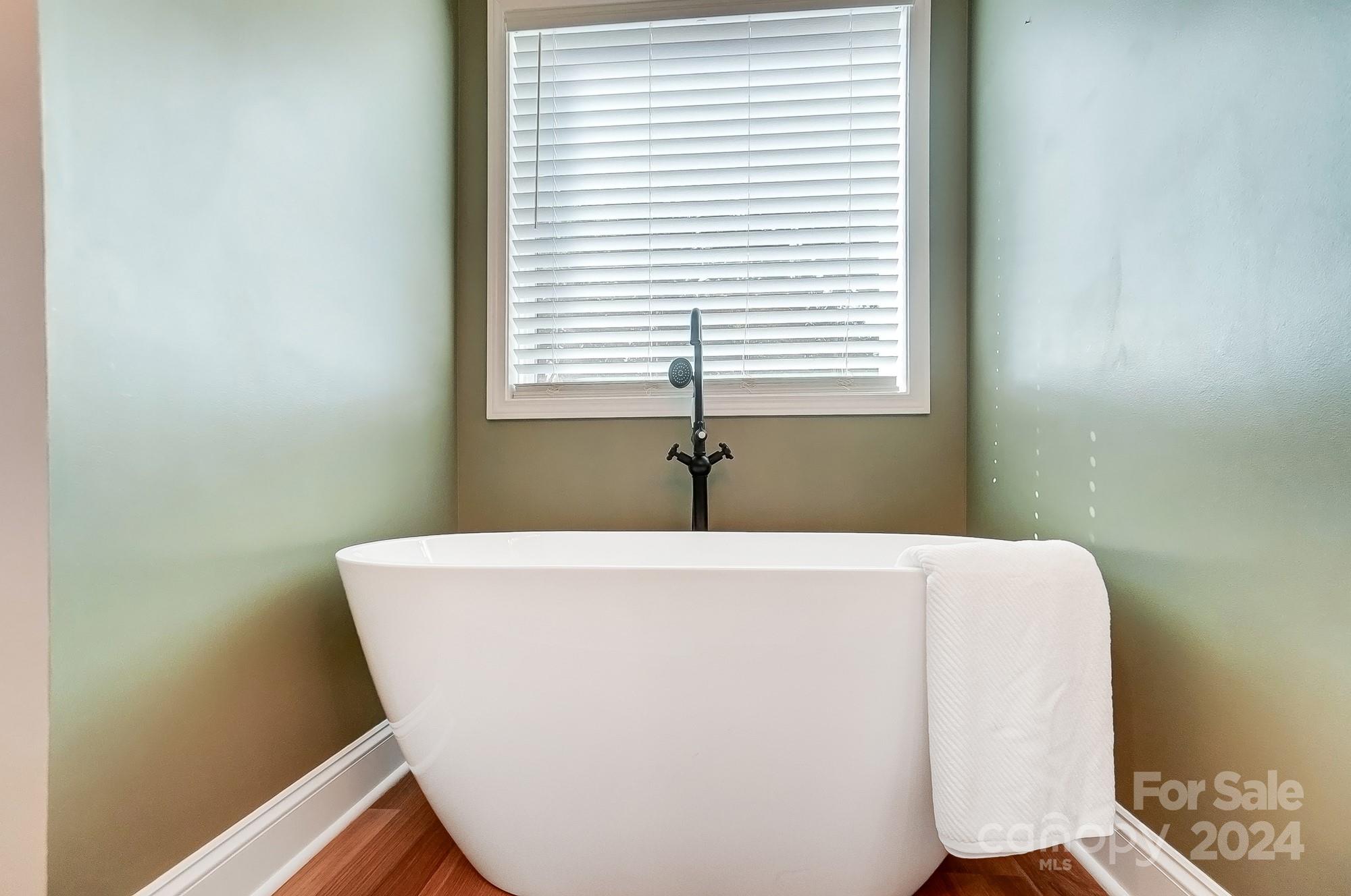 1413 Hamilton Crossroads Road Marshville, NC 28103 - Photo 24 of 42 a white tub sitting in a bathroom next to a window