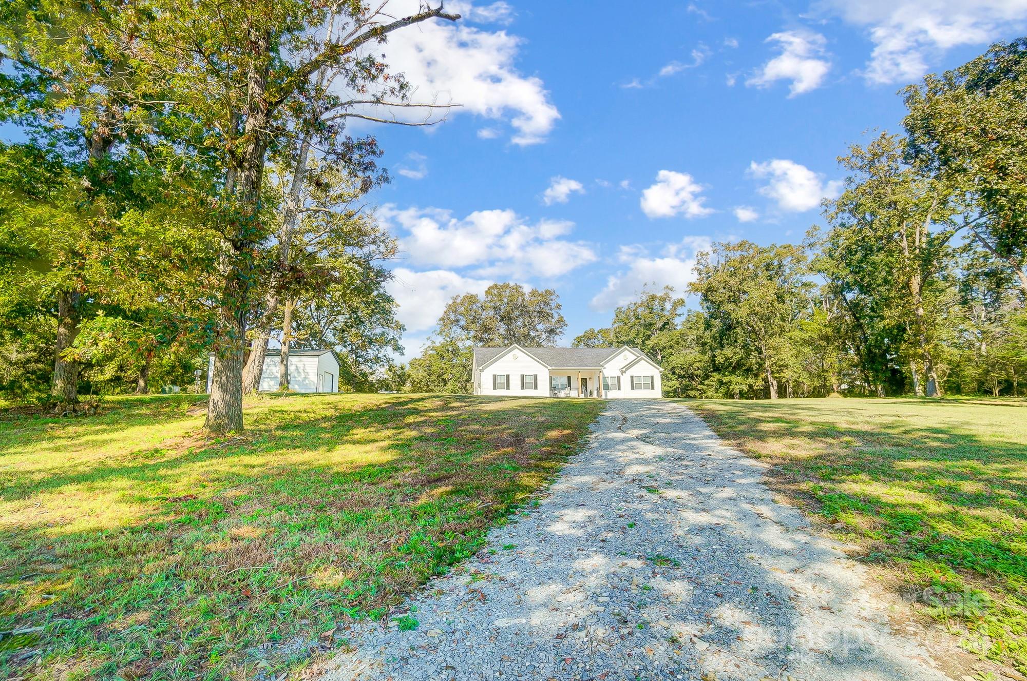 1413 Hamilton Crossroads Road Marshville, NC 28103 - Photo 3 of 42 a view of a big yard with large trees and plants
