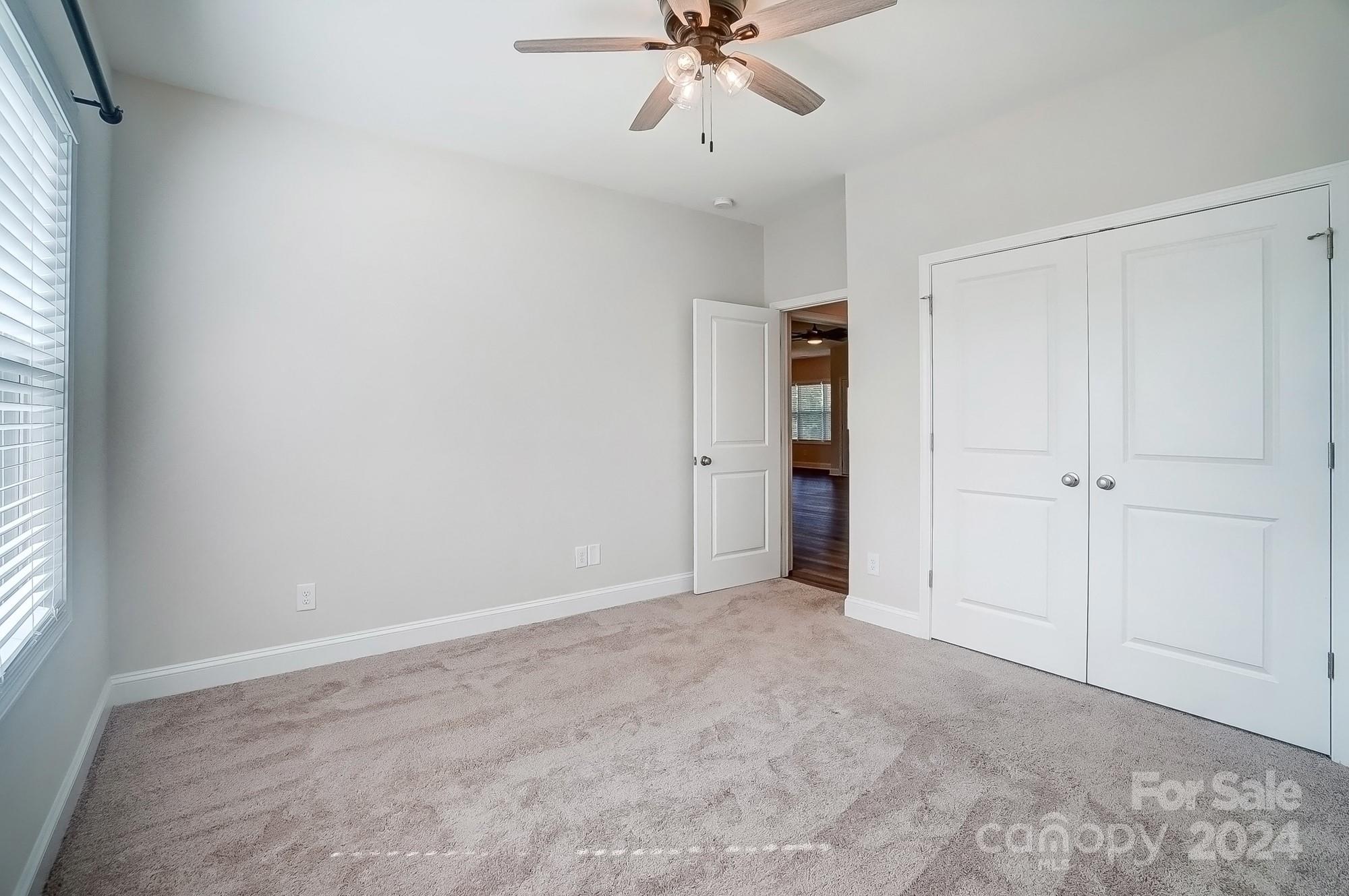 1413 Hamilton Crossroads Road Marshville, NC 28103 - Photo 32 of 42 an empty room with closet and windows