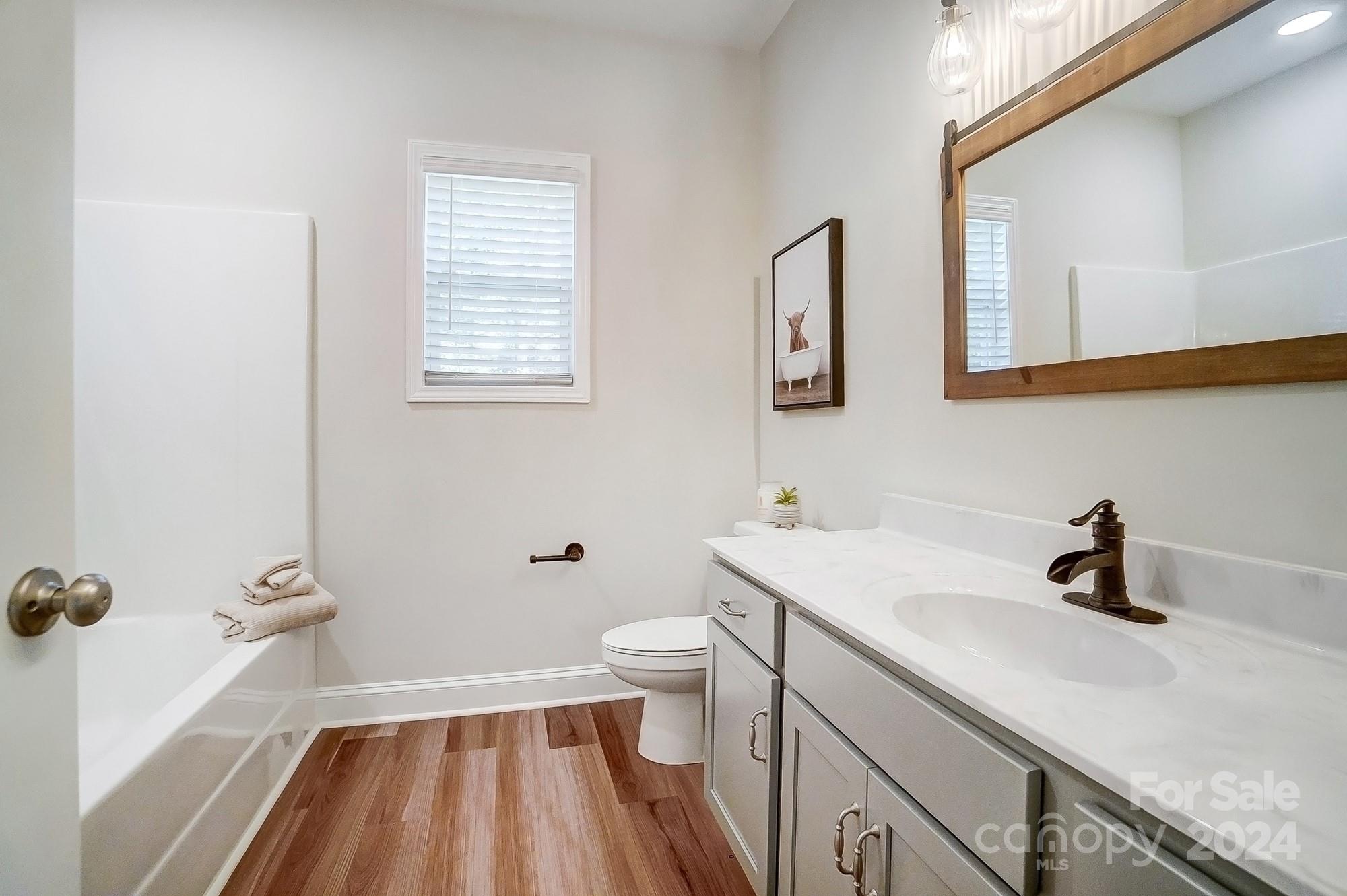 1413 Hamilton Crossroads Road Marshville, NC 28103 - Photo 33 of 42 a bathroom with a sink a toilet and a mirror