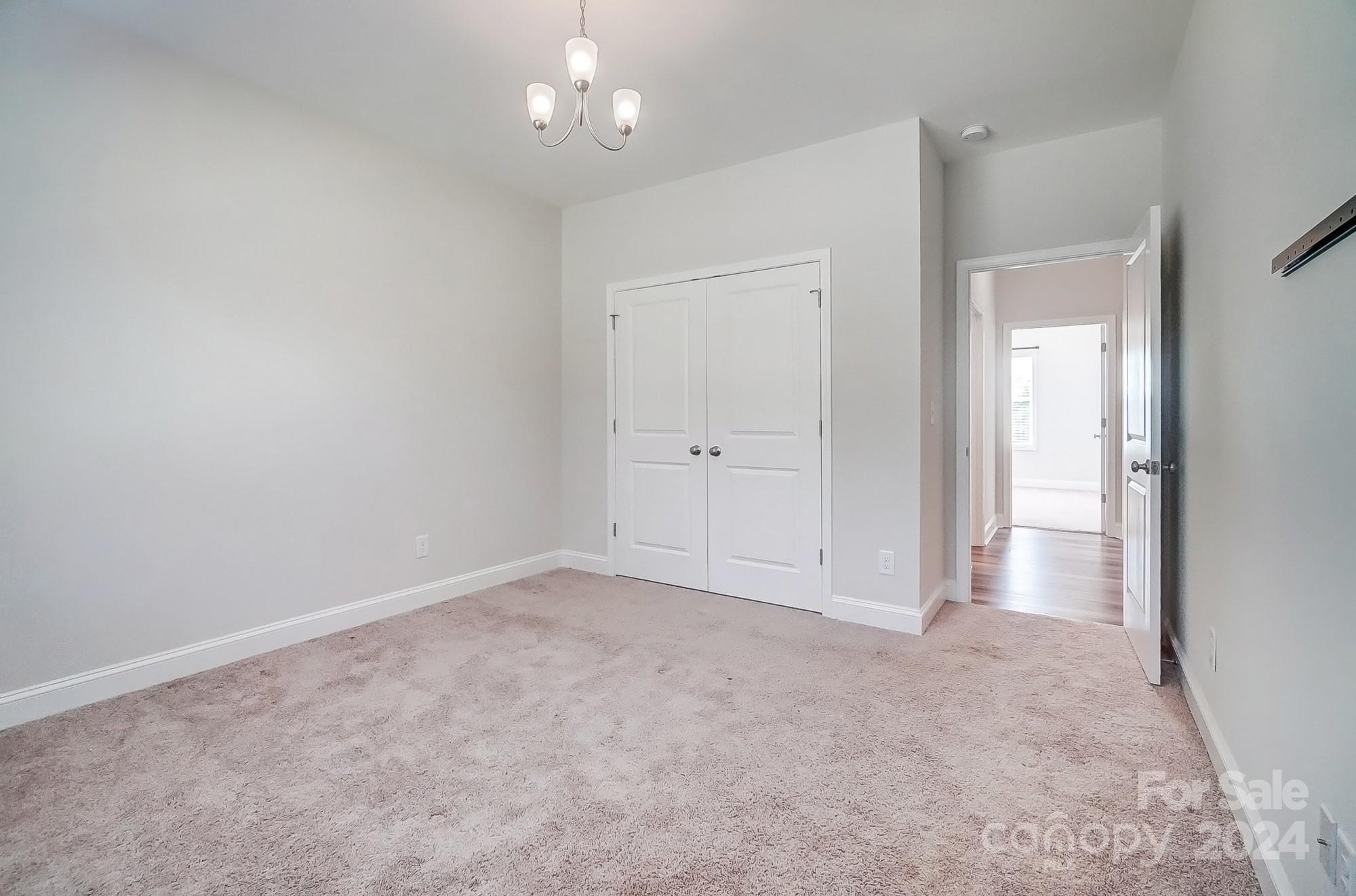 1413 Hamilton Crossroads Road Marshville, NC 28103 - Photo 35 of 42 an empty room with chandelier fan