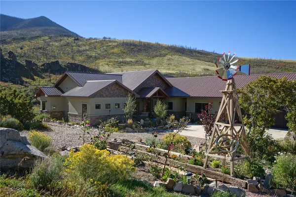 a view of house with yard and sitting area