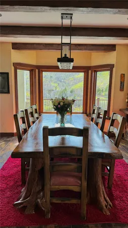 a view of a dining room with furniture and window