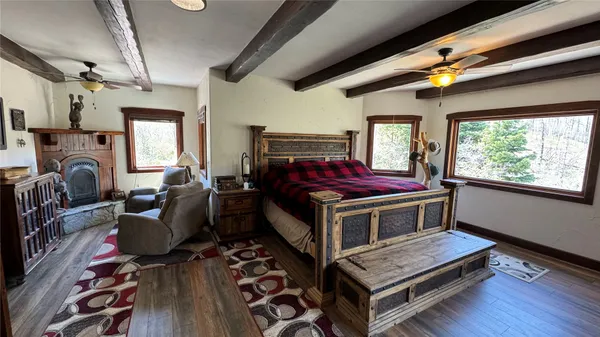 a bedroom with furniture and a window