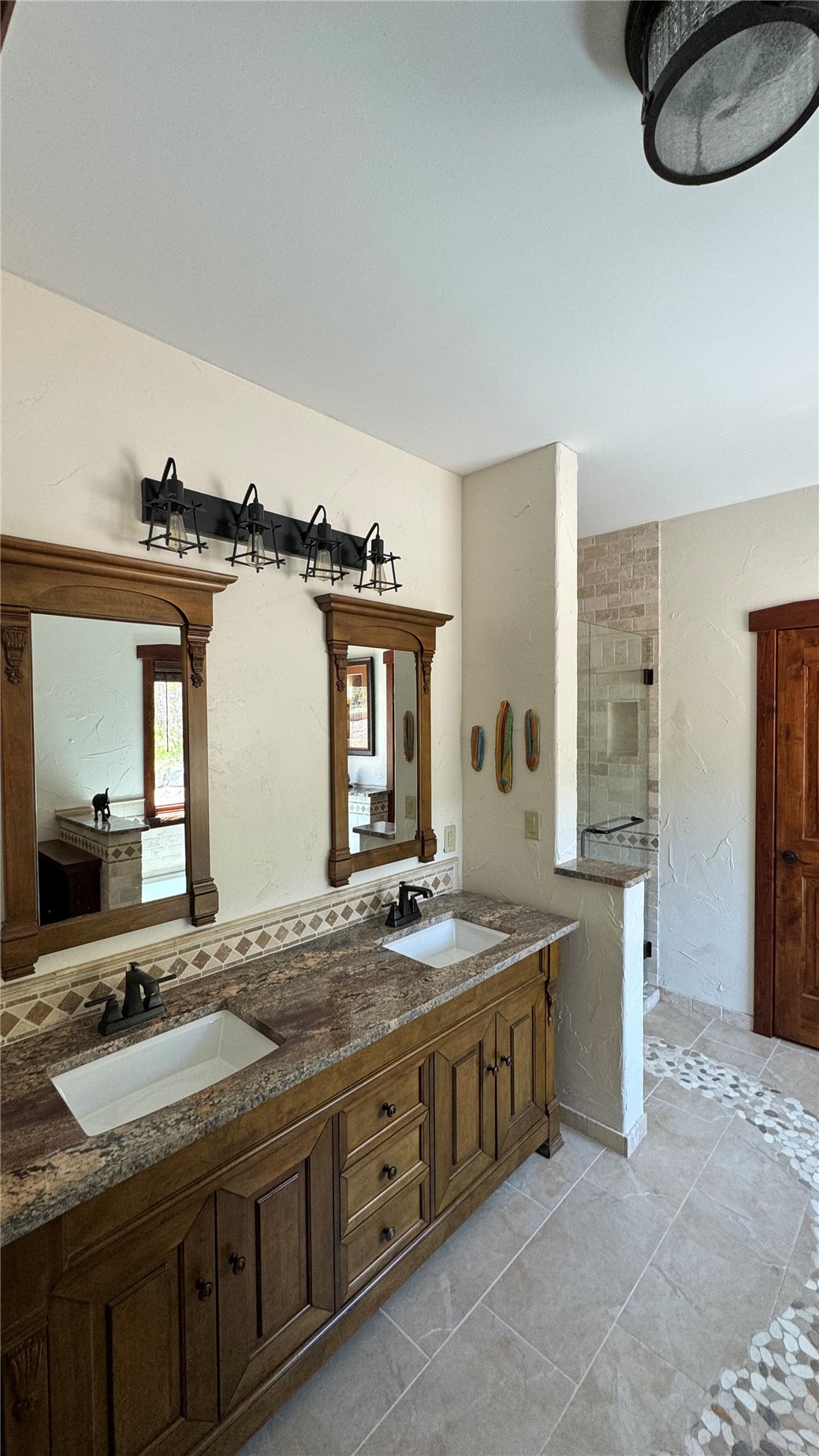 1833 Yellowstone Creek Road Walsenburg, CO 81089 - Photo 26 of 50 a bathroom with a granite countertop sink and a mirror