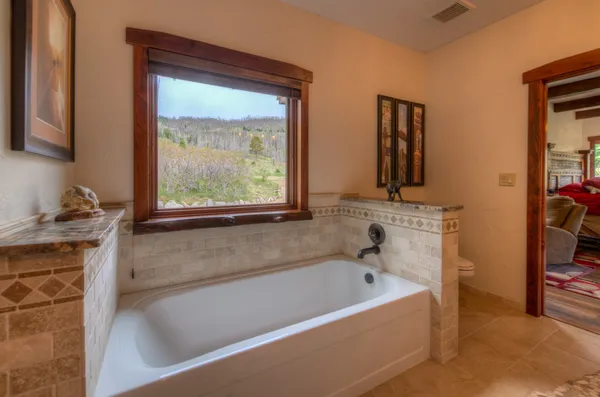 a bathroom with a bathtub and a window