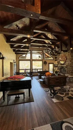 a living room with lots of furniture and a wooden floor