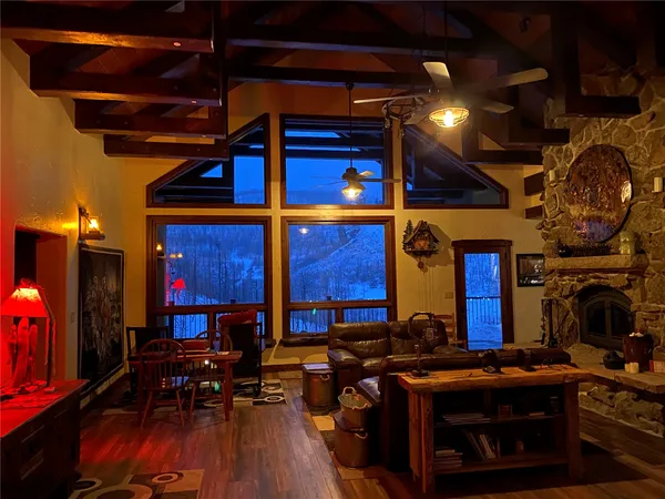 a room with wooden floors table and chairs