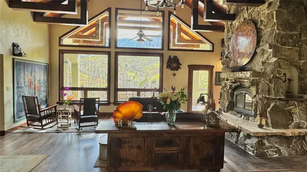 a view of a living room with furniture and floor to ceiling window