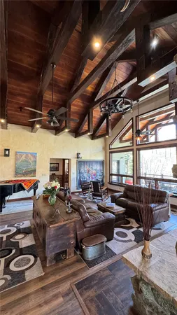 a living room with lots of furniture and a chandelier