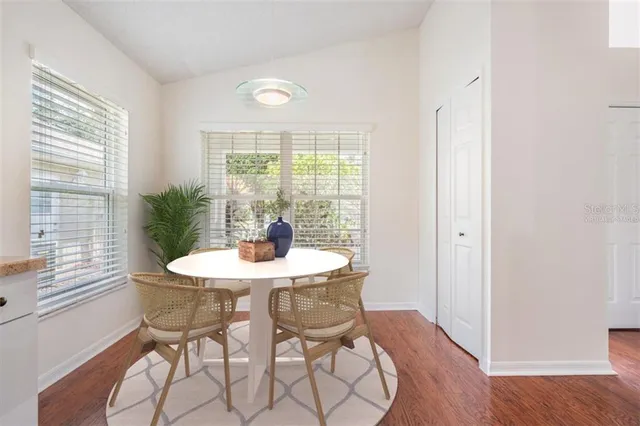 a view of a dining room with furniture window and wooden floor