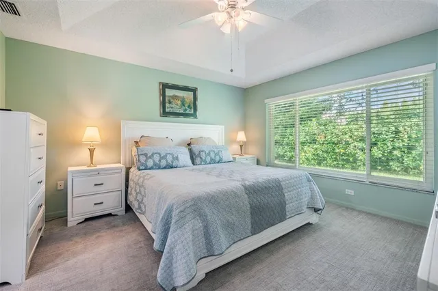 a spacious bedroom with a bed and a large window