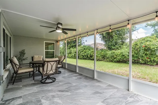 a view of an empty room with furniture and floor to ceiling window