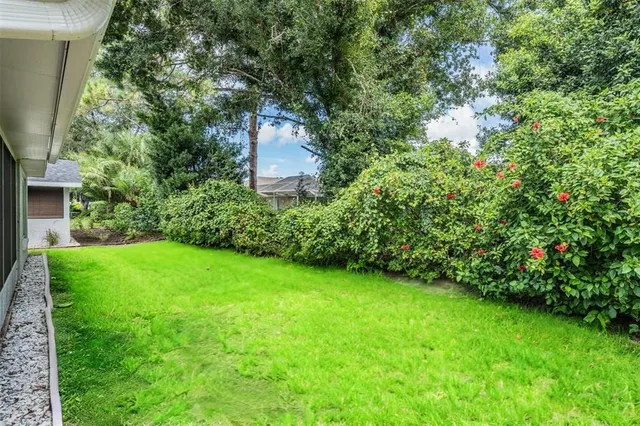 a view of a backyard with potted plants and a bench