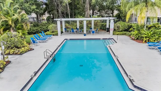a view of swimming pool with chairs