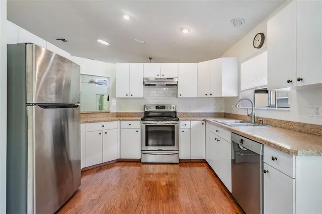 a kitchen with a refrigerator a sink and dishwasher