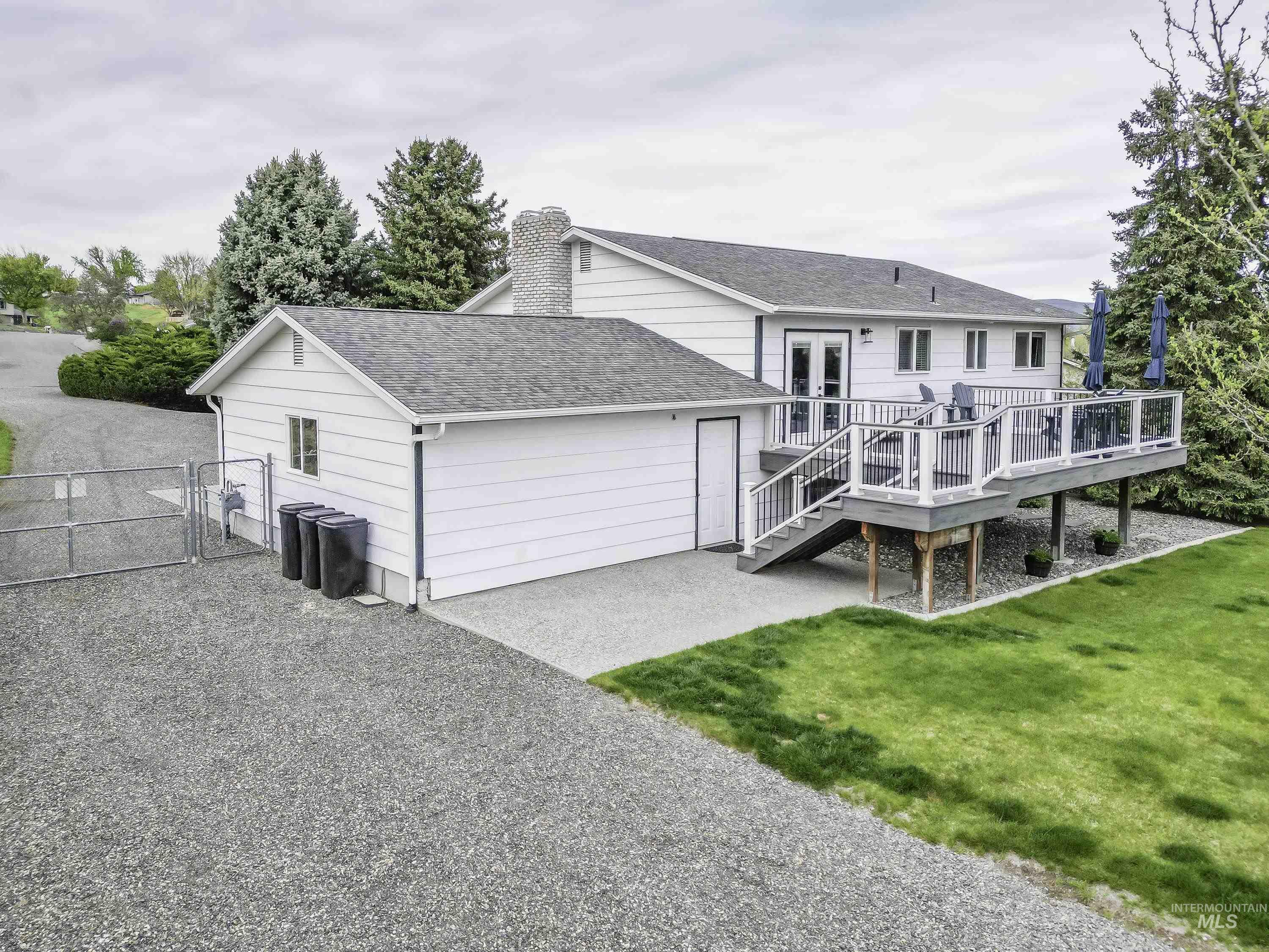 2945 25th Street Clarkston, WA 99403 - Photo 15 of 46 Rear view of house featuring a gate, a wooden deck, a shingled roof, a chimney, and french doors